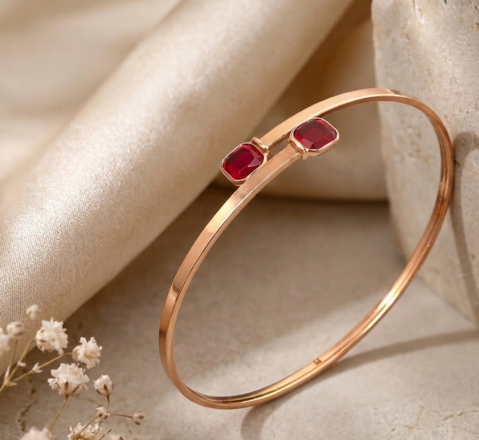 Elegant Gold-Plated Open Cuff Bangle with Twin Ruby Red Gemstones
